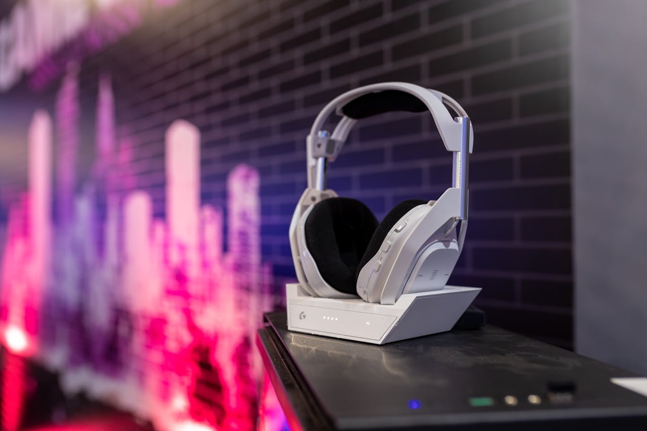 White headphones on a sleek stand with a vibrant city backdrop, ideal for tech advertising.